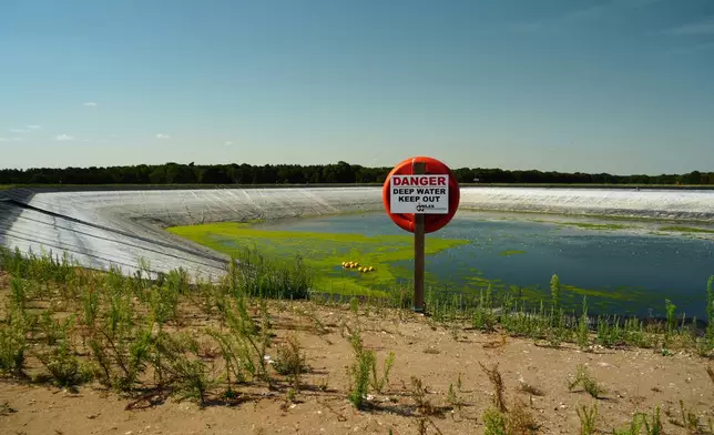 The 'Summer Pit' water reservoir on the Elveden Estate shows low water levels amid a nationwide drought, in Thetford, England, Tuesday, Aug. 11, 2026. (AP Photo/Mustakim Hasnath)
