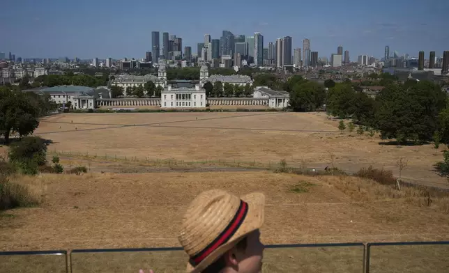 A general view of Greenwich Park amid dried grass in London, Tuesday, Aug. 11, 2026. (AP Photo/Kin Cheung)