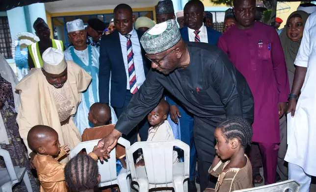 Kwara state Gov. Abdulrahman Abdulrazaq greets children at a hotel in Ilorin, Nigeria, Friday, Aug. 7, 2026, where they are staying after being rescued from a forest where they were held following their abduction from the Woro community by gunmen in February. (AP Photo/Abubakar Khadijat)