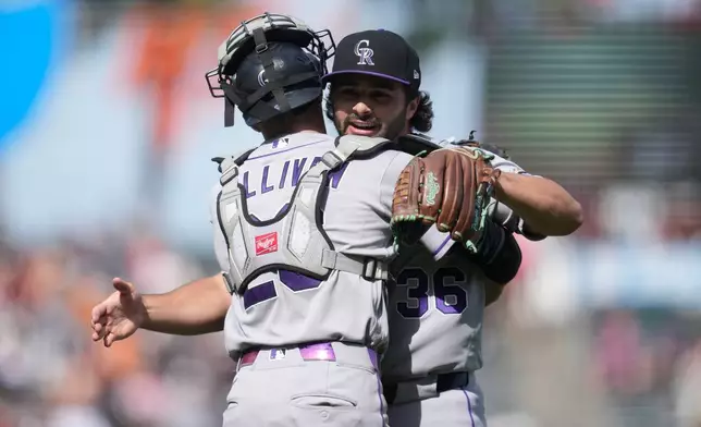 Colorado Rockies catcher Brett Sullivan, left, celebrates with pitcher Zach Agnos after a baseball game against the San Francisco Giants, Sunday, Aug. 16, 2026, in San Francisco. (AP Photo/Jeff Chiu)