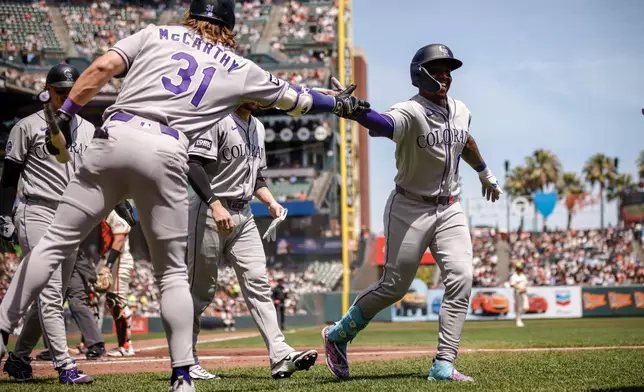 Colorado Rockies teammates congratulate Adael Amadodr (1) after his three-run home run in the first inning of a baseball game against the San Francisco Giants in San Francisco, Sunday, Aug. 16, 2026. (Carlos Avila Gonzalez/San Francisco Chronicle via AP)