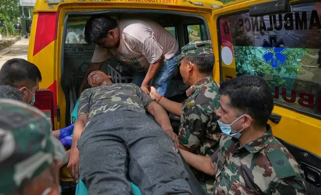 An injured rescued person from flash flooding is taken to a hospital in Nepal's Nuwakot district, Friday, Aug. 28, 2026. (AP Photo/Rajesh Kumar Singh)