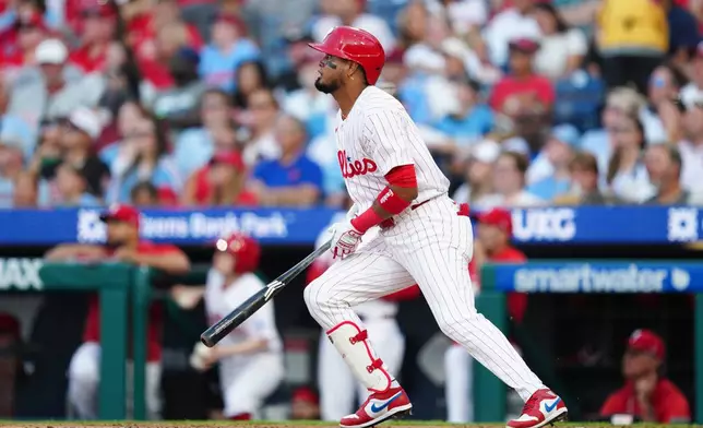 Philadelphia Phillies' Luis Arraez watches his two-run home run off Miami Marlins pitcher Sandy Alcantara during the third inning of a baseball game, Wednesday, Aug. 19, 2026, in Philadelphia. (AP Photo/Derik Hamilton)