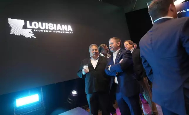 Guests gather before the start of an event with Louisiana Gov. Jeff Landry and SpaceX announcing a deal to build a new spaceport in Louisiana, Tuesday, Aug. 25, 2026, in Abbeville, La. (AP Photo/Gerald Herbert)