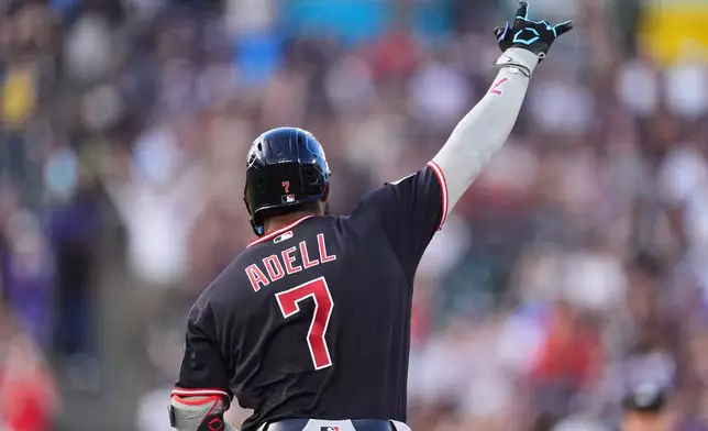 Cleveland Guardians' Jo Adell gestures to the bullpen as he circles tha bases after hitting a three-run home run off Colorado Rockies starting pitcher Gabriel Hughes in the fourth inning of a baseball game Saturday, Aug. 22, 2026, in Denver. (AP Photo/David Zalubowski)