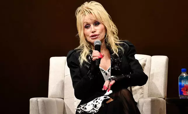 FILE - Dolly Parton speaks to a audience gathered to celebrate the expansion of the Imagination Library of Kentucky at the Lyric Theatre in Lexington, Ky., on Aug. 27, 2024. (AP Photo/Timothy D. Easley, File)