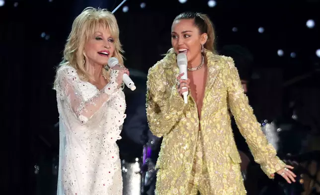 FILE - Dolly Parton, left, and Miley Cyrus perform "Jolene" at the 61st annual Grammy Awards in Los Angeles on Feb. 10, 2019. (Photo by Matt Sayles/Invision/AP, File)