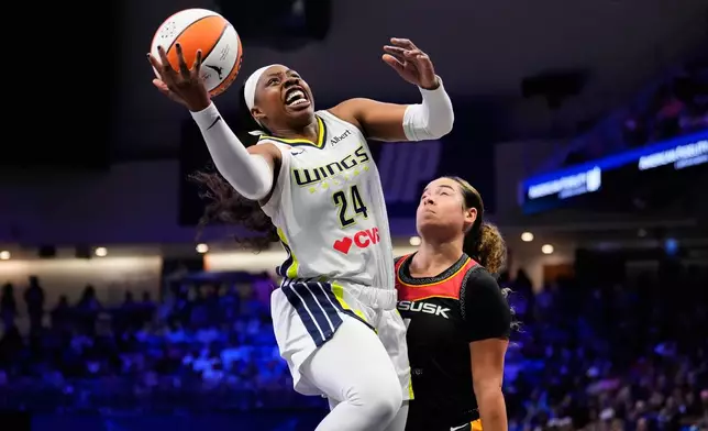 Dallas Wings guard Arike Ogunbowale (24) shoots over Connecticut Sun's Charlisse Leger-Walker, right, defends in the first half of a WNBA basketball game Sunday, Aug. 30, 2026, in Arlington, Texas. (AP Photo/Tony Gutierrez)