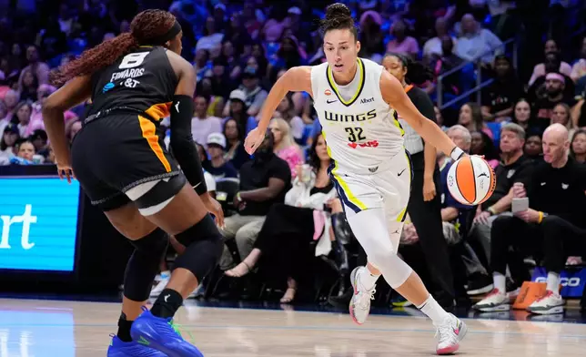 Dallas Wings forward Jessica Shepard (32) drives to the basket as Connecticut Sun's Aaliyah Edwards (8) defends in the first half of a WNBA basketball game Sunday, Aug. 30, 2026, in Arlington, Texas. (AP Photo/Tony Gutierrez)