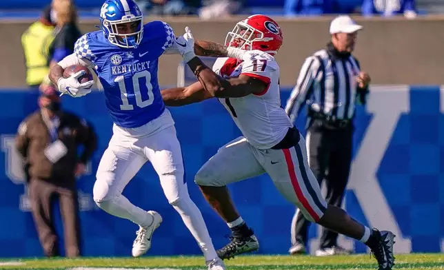 FILE - Georgia linebacker Nakobe Dean (17) tries to tackle Kentucky running back Asim Rose Jr. (10) during the second half of an NCAA college football game Oct. 31, 2020, in Lexington, Ky. (AP Photo/Bryan Woolston, File)