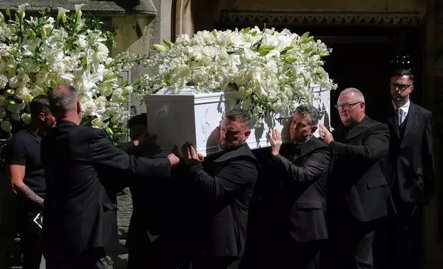 The coffin is taken from Swansea Minster following the funeral of Bonnie Tyler in Swansea, Wales, Monday, Aug. 17, 2026. (AP Photo/Alastair Grant)