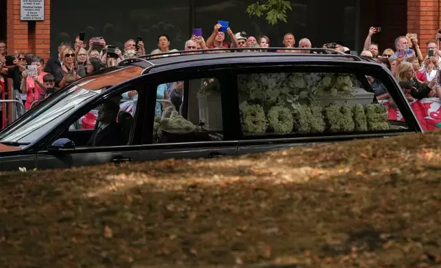 The hearse with the coffin arrives at Swansea Minster for the funeral of Bonnie Tyler in Swansea, Wales, Monday, Aug. 17, 2026. (AP Photo/Alastair Grant)