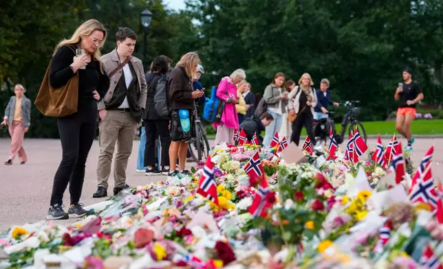 Flowers and Norway's flags are laid at the Palace Square in Oslo, Friday, Aug. 26, 2026 (Ole Berg-Rusten/NTB Scanpix via AP)