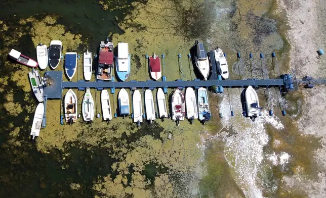 Boats sit on dry ground as water levels have dropped on the Danube River in Novi Sad, Serbia, Wednesday, July 29, 2026. (AP Photo/Darko Vojinovic)