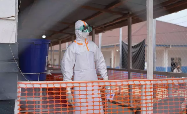 A health worker in protective gear looks on at an Ebola treatment centre in Bunia, Congo, Monday, Aug. 10, 2026. (AP Photo/Dieudonne Dirole)