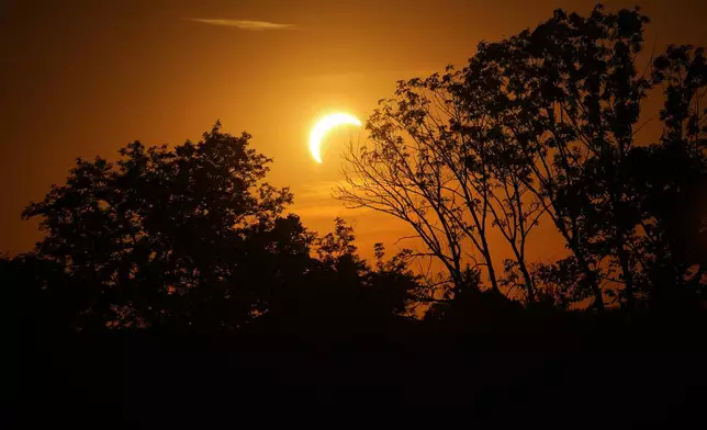 The moon partially obscures the sun during a solar eclipse before the UEFA Super Cup soccer match between Paris Saint-Germain and Aston Villa in Salzburg, Austria, Wednesday, Aug. 12, 2026. (AP Photo/Darko Vojinovic)