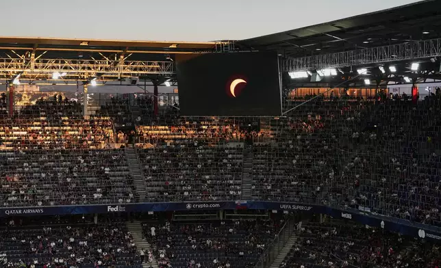A video feed of the solar eclipse is shown on a stadium display before the UEFA Super Cup soccer match between Paris Saint-Germain and Aston Villa in Salzburg, Austria, Wednesday, Aug. 12, 2026. (AP Photo/Darko Vojinovic)