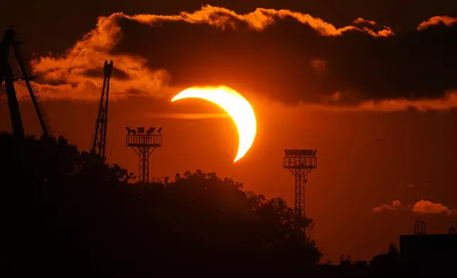 The moon partially covers the sun during a solar eclipse seen from Tallinn harbor, Estonia, Wednesday, Aug. 12, 2026. (AP Photo/Sergei Grits)