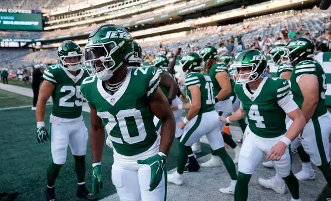 New York Jets running back Breece Hall (20) leads his team onto the field before a preseason NFL football game against the Tampa Bay Buccaneers, Friday, Aug. 14, 2026, in East Rutherford, N.J. (AP Photo/Seth Wenig)