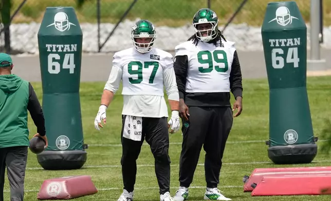 FILE - New York Jets' Harrison Phillips (97) and T'Vondre Sweat (99) participate in an NFL football practice in Florham Park, N.J., June 10, 2026. (AP Photo/Seth Wenig, File)