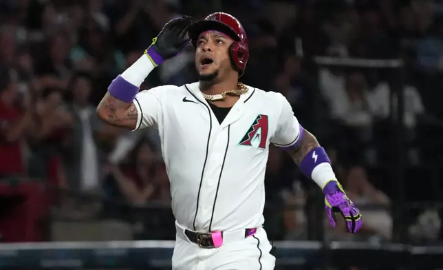 Arizona Diamondbacks' Ketel Marte reacts after hitting a two-run home run against the Los Angeles Dodgers in the first inning of a baseball game, Sunday, Aug 9, 2026, in Phoenix. (AP Photo/Rick Scuteri)