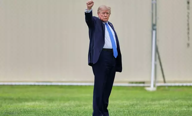 President Donald Trump gestures as he walks to board Marine One on the Ellipse, Friday, Aug. 14, 2026, near the White House in Washington. (AP Photo/Mark Schiefelbein)