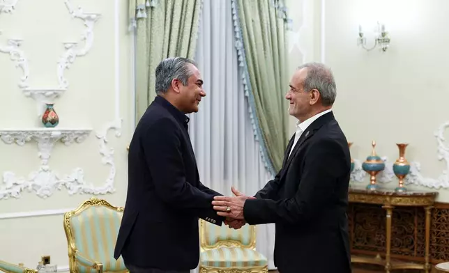 In this photo released by the Iranian Presidency Office, Iranian President Masoud Pezeshkian, right, greets Pakistan's Interior Minister Mohsin Naqvi at the start of their meeting in Tehran, Iran, Tuesday, Aug. 11, 2026. (Iranian Presidency Office via AP)