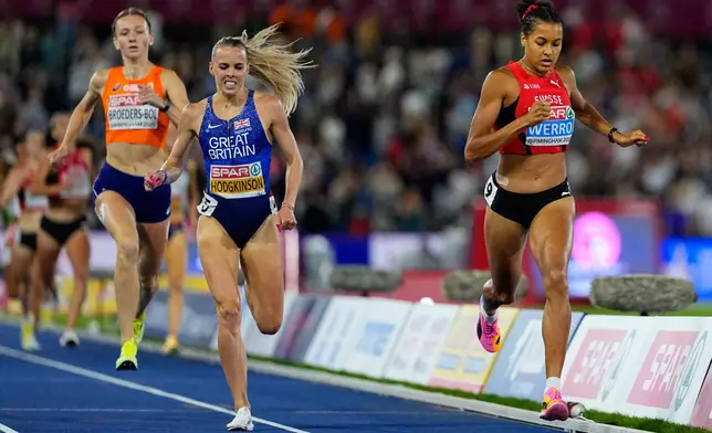 Audrey Werro of Switzerland crosses the line to win the gold medal ahead of Keely Hodgkinson of Britain and Femke Broeders-Bol of the Netherlands in the women's 800 meters final at the European Athletics Championships in Birmingham, England, Friday, Aug. 14, 2026. (AP Photo/Petr David Josek)