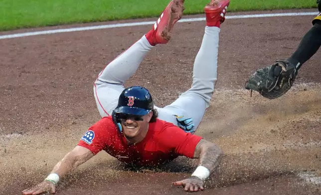Boston Red Sox's Jarren Duran slides past the glove of Pittsburgh Pirates catcher Henry Davis to score from third on a sacrifice fly by Nick Sogard off Pirates pitcher Bubba Chandler during the fifth inning of a baseball game in Pittsburgh, Friday, Aug. 14, 2026. (AP Photo/Gene J. Puskar)