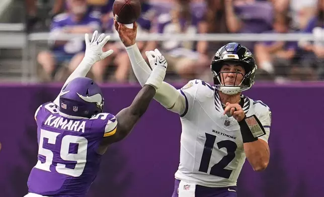 Baltimore Ravens quarterback Joe Fagnano (12) throws against Minnesota Vikings linebacker Bangally Kamara (59) during the second half of an NFL preseason football game, Saturday, Aug. 22, 2026, in Minneapolis. (AP Photo/Abbie Parr)