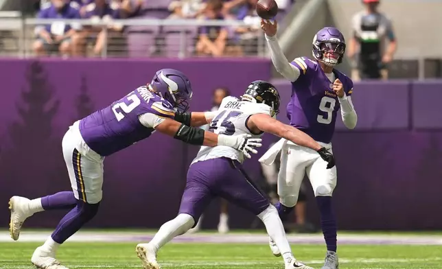 Minnesota Vikings quarterback J.J. McCarthy (9) throws against pressure by Baltimore Ravens linebacker Ethan Burke (45) during the first half of an NFL preseason football game, Saturday, Aug. 22, 2026, in Minneapolis. (AP Photo/Abbie Parr)