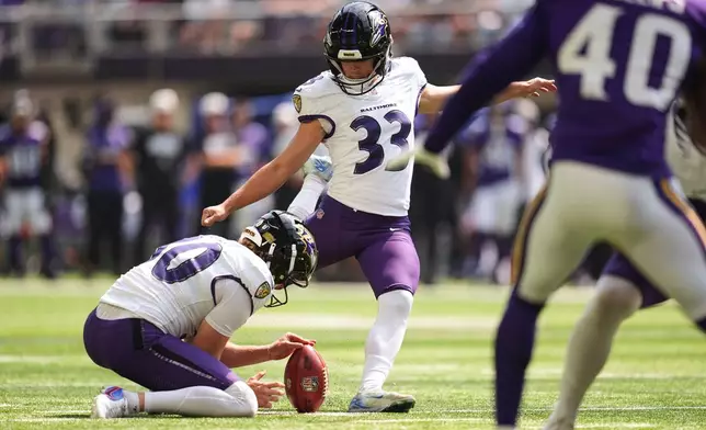 Baltimore Ravens place kicker Tyler Loop (33), with punter Ryan Eckley holding, kicks a 20-yard field goal during the second half of an NFL preseason football game against the Minnesota Vikings, Saturday, Aug. 22, 2026, in Minneapolis. (AP Photo/Abbie Parr)