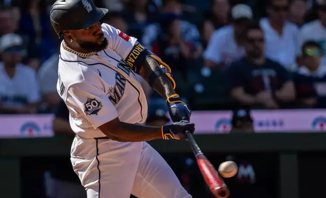 Seattle Mariners' Randy Arozarena hits a double during the ninth inning of a baseball game against the Minnesota Twins, Saturday, Aug. 1, 2026, in Seattle. (AP Photo/Stephen Brashear)