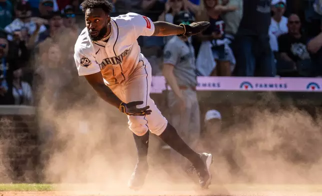 Seattle Mariners' Randy Arozarena scores during the ninth inning of a baseball game against the Minnesota Twins, Saturday, Aug. 1, 2026, in Seattle. (AP Photo/Stephen Brashear)