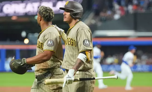 San Diego Padres' Manny Machado, right, comforts Xander Bogaerts after Bogaerts was tagged out at home plate during the second inning of a baseball game against the New York Mets Monday, Aug. 17, 2026, in New York. (AP Photo/Frank Franklin II)