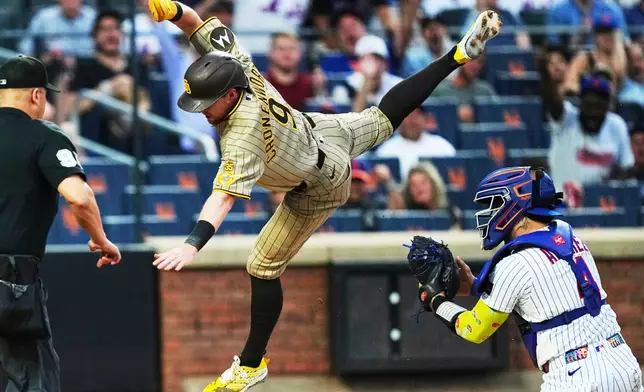 New York Mets' Francisco Alvarez (4) tags out San Diego Padres' Jake Cronenworth (9) at home plate during the first inning of a baseball game Monday, Aug. 17, 2026, in New York. (AP Photo/Frank Franklin II)