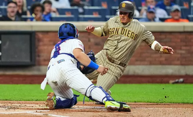 New York Mets' Francisco Alvarez, left, tags out San Diego Padres' Manny Machado during the first inning of a baseball game Monday, Aug. 17, 2026, in New York. (AP Photo/Frank Franklin II)