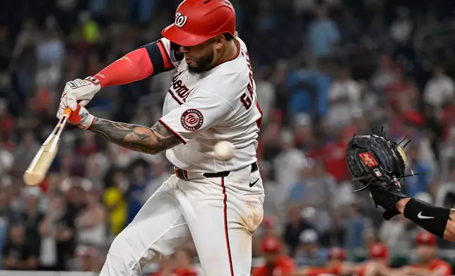 Washington Nationals' Luis García Jr. swings the bat for strike three for the final out of a baseball game with two men on base in the ninth inning during a loss to the Toronto Blue Jays, Monday, July 27, 2026, in Washington. (AP Photo/John McDonnell)