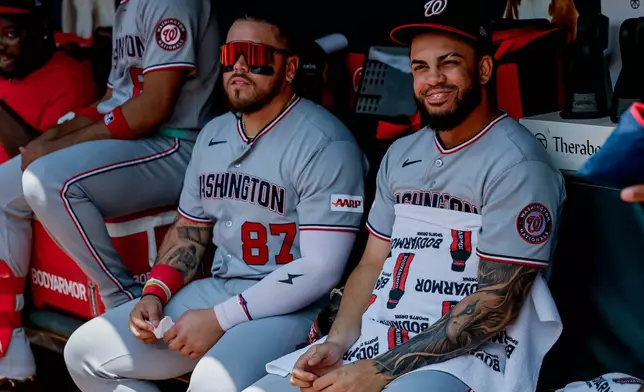 Washington Nationals' Luis García Jr., right, sits in the dugout with Andrés Chaparro (87) after he was scratched from the starting lineup before a baseball game against the Atlanta Braves, Sunday, Aug. 2, 2026, in Atlanta. (AP Photo/Erik S. Lesser)