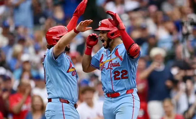 St. Louis Cardinals' Joshua Baez (22) celebrates with teammate Alec Burleson, left, after hitting a two-run home run during the sixth inning of a baseball game against the Chicago Cubs in Chicago, Saturday, Aug. 15, 2026. (AP Photo/Paul Beaty)
