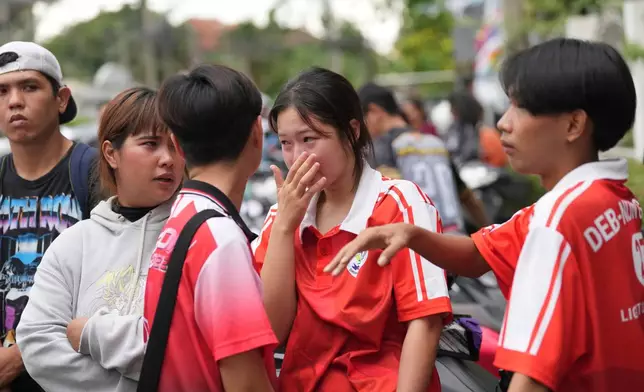 A schoolgirl cries outside her school where deaths and injuries were reported after a shooting in Thailand's Nonthaburi province, Friday, Aug. 7, 2026. (AP Photo/Sakchai Lalit)