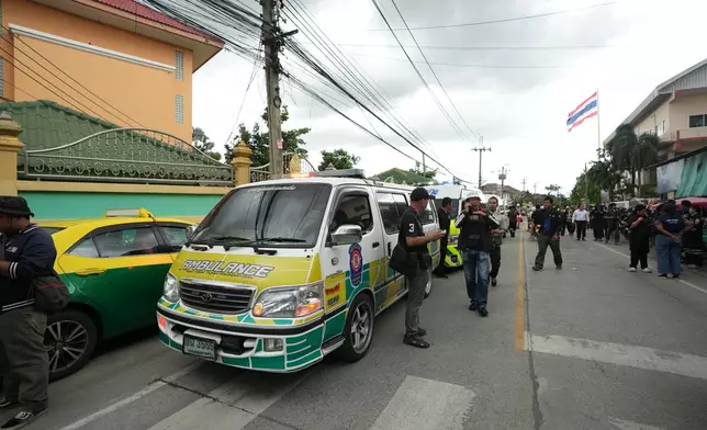 A crowd gathers outside a school where deaths and injuries were reported after a shooting in Thailand's Nonthaburi province, Friday, Aug. 7, 2026. (AP Photo/Sakchai Lalit)
