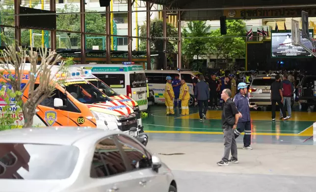Ambulances stand in wait outside a school where deaths and injuries were reported after a shooting in Thailand's Nonthaburi province, Friday, Aug. 7, 2026. (AP Photo/Sakchai Lalit)
