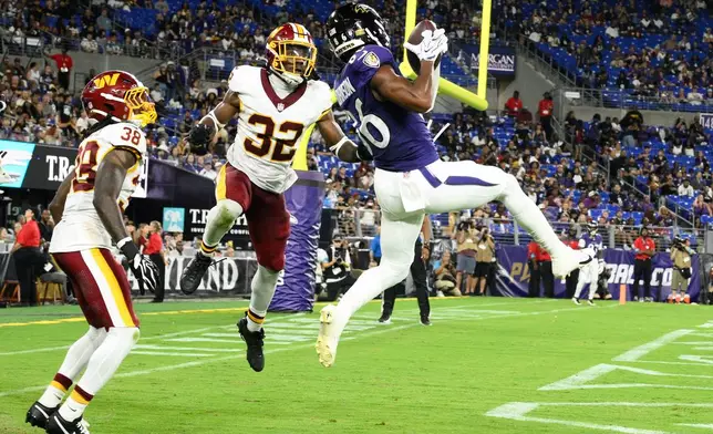 Baltimore Ravens wide receiver Cornelius Johnson (86) catches a pass for a touchdown as Washington Commanders' Qwuantrezz Knight Sr. (32) and Fred Davis II (38) defend during the second half of an NFL preseason football game, Friday, Aug. 28, 2026, in Baltimore. (AP Photo/Nick Wass)