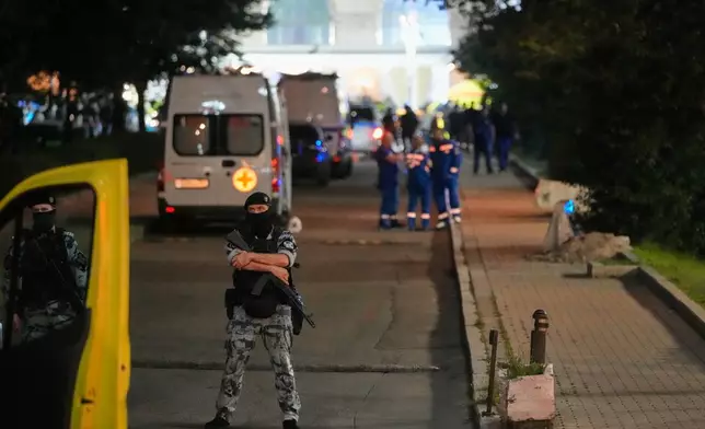 A policeman stands guard near the site where an improvised explosive device detonated at a restaurant in central Moscow, Saturday, Aug. 1, 2026. (AP Photo/Pavel Bednyakov)