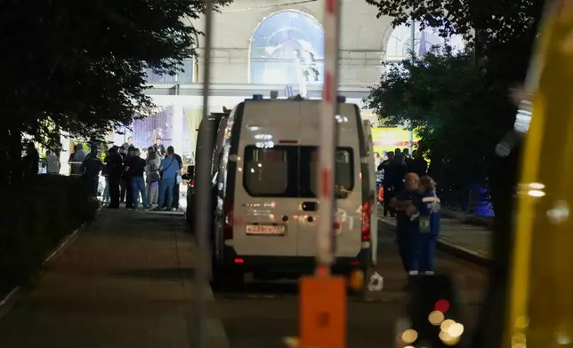 Ambulances and special services vehicles are parked near the site where an improvised explosive device detonated at a restaurant in central Moscow, Saturday, Aug. 1, 2026. (AP Photo/Pavel Bednyakov)