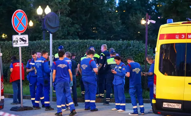 Paramedics gather near a deadly explosion at a restaurant in Moscow, Saturday, Aug. 1, 2026. (Sergei Vedyashkin/Moscow News Agency via AP)