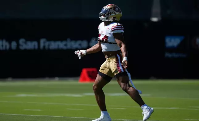 San Francisco 49ers middle linebacker Fred Warner reacts toward fans during the NFL football team's training camp Friday, July 31, 2026, in Santa Clara, Calif. (AP Photo/Jeff Chiu)
