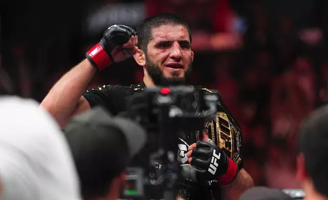 Islam Makhachev reacts after defeating Ian Machado Garry in a welterweight title fight at the UFC 330 mixed martial arts event Sunday, Aug. 16, 2026, in Philadelphia. (AP Photo/Derik Hamilton)