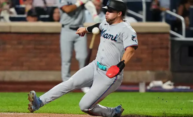 Miami Marlins' Jakob Marsee scores on a single by Joe Mack during the fifth inning of a baseball game against the New York Mets Friday, July 31, 2026, in New York. (AP Photo/Frank Franklin II)